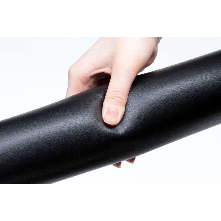 Hand holding a roll of black vinyl wrap against a white background