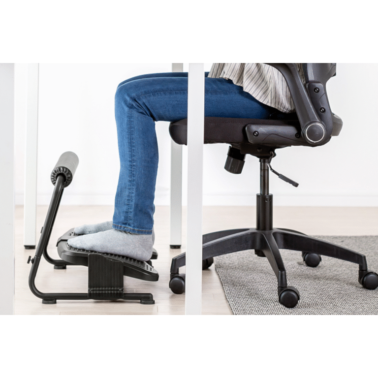 Person using a footrest with an office chair on a light-colored floor.