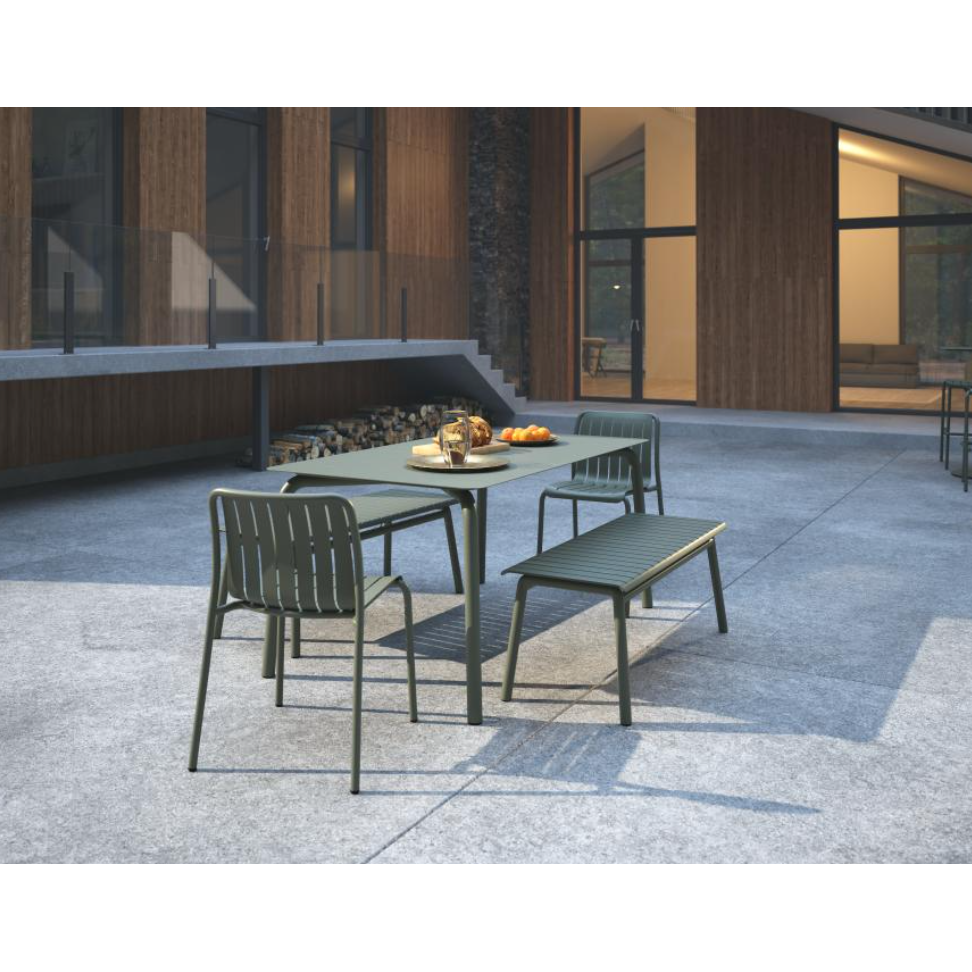 Outdoor patio set with table, chairs, and bench on a concrete patio.