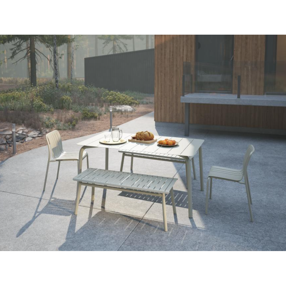 Outdoor patio set with table, chairs, and bench on a concrete patio.